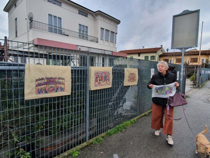 Fig. 6: A resident of Macrolotto Zero collects one of the nianhua prints posted in Via Pistoiese.